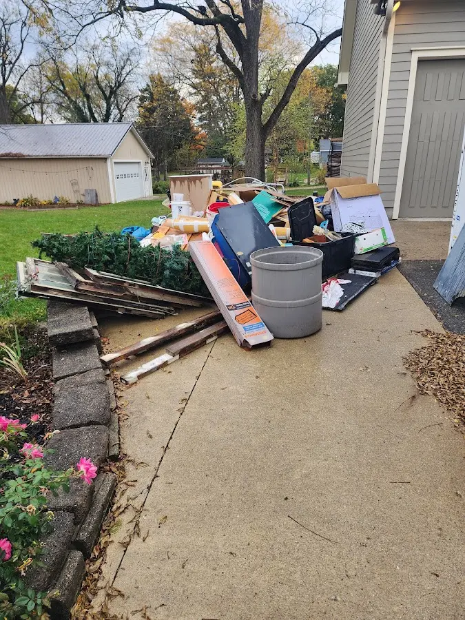 Dumpster being loaded with debris for Estate Cleanout Dumpster Rental in Stoneham